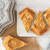 Snowflake shortbread cookies on a platter with snowflake shortbread pan in upper left hand corner.