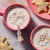 Classic Milk Hot Chocolate in mugs with rainbow sprinkles and star shaped sugar cookies.