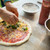 Adding toppings to pizza using Dellamore Pizza Sauce