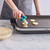 Teaspoon scoop being used to scoop chocolate chip cookie dough