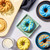 Buttermilk doughnut mix made in the French twist doughnut pan topped with yellow, blue and green melting morsels.