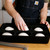 We see a person placing pizza dough in the Pizza Dough Proofing Tray