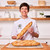 Instructor Amber Eisler holding baked baguettes