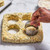 Biscuits being cut with round biscuit cutters. The biscuits are made with Cheddar Chive Scone and Biscuit Mix