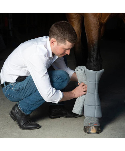 Man putting Incrediwear Standing bandage on horse's front leg.