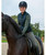 Female rider on horse wearing the HKM heated winter vest.