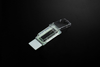 NEST clear single-well cell culture chamber slide with glass base and hinged lid on dark background.