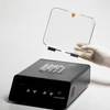 A gloved hand holds the clear plastic lid above a black Labnet digital dry bath loaded with microtubes.