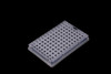 An angled view of a clear plastic 96-well PCR plate against a black background.