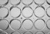 Top-down view of a clear plastic 12-well cell culture plate with well coordinates B3 through D6.