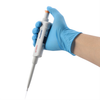 A gloved hand holding a white 4E's single-channel adjustable pipette with an orange plunger and tip.