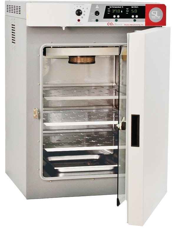 Sheldon Manufacturing grey CO2 incubator with open white door revealing stainless steel shelves.