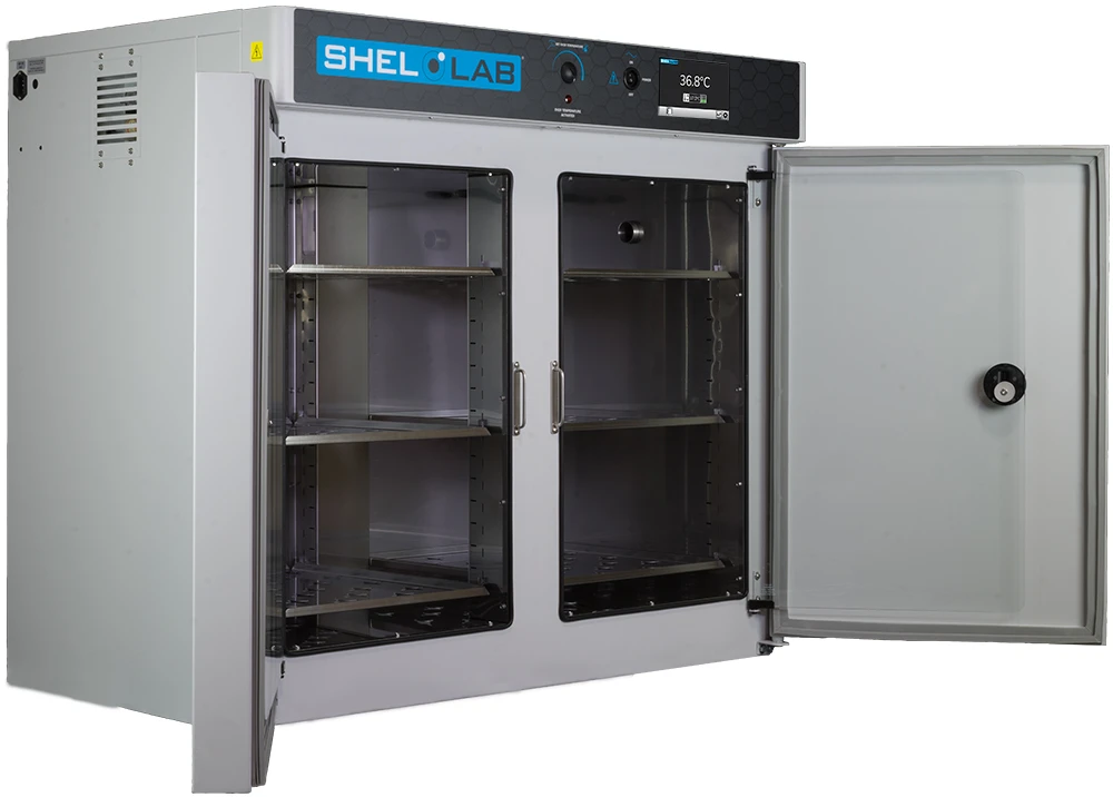 SHEL LAB side-by-side laboratory incubator with open doors, showing stainless steel interior and touch screen display.