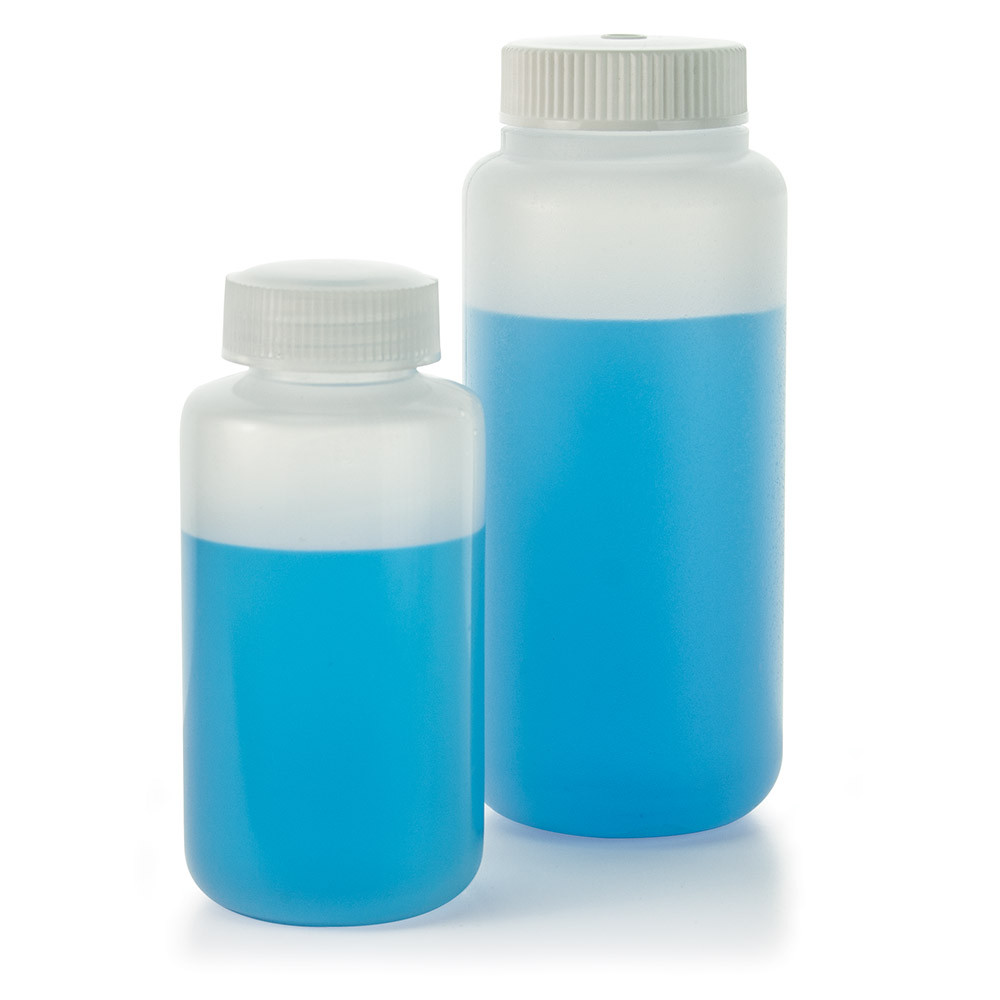 Two translucent plastic centrifuge bottles filled with blue liquid and white caps.