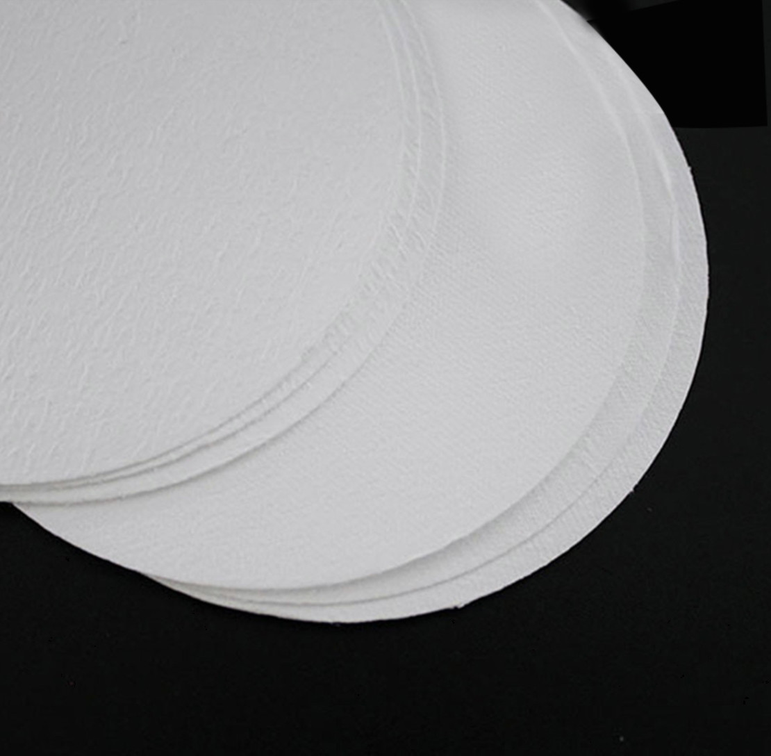 A stack of white, round MCE membrane filters viewed from a high angle.