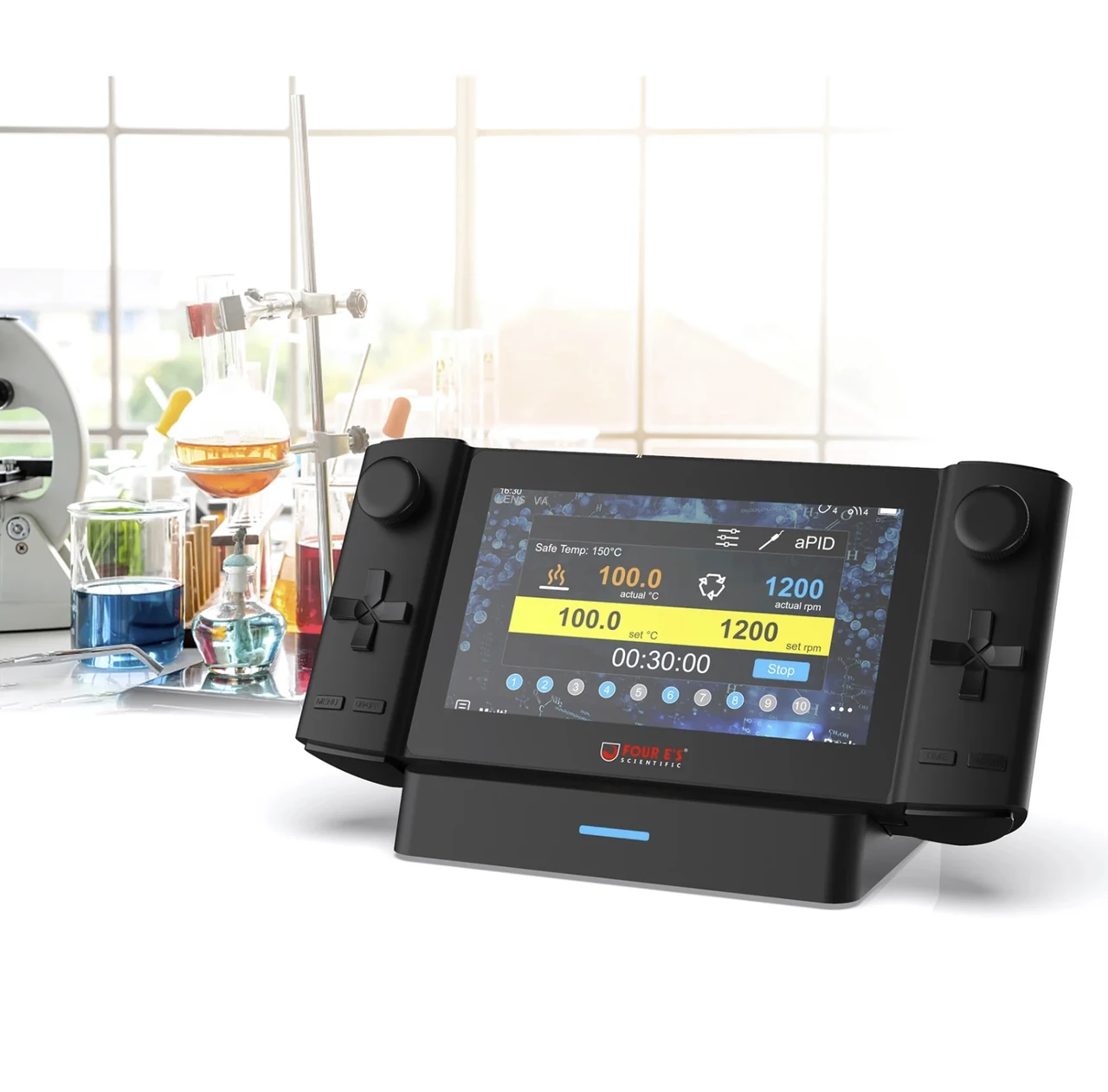 Black handheld magnetic hotplate stirrer controller hub on a charging stand with a touchscreen display in a laboratory.