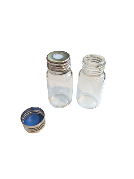 Silver magnetic screw cap with white septa on a glass vial, with a matching cap and vial beside it.