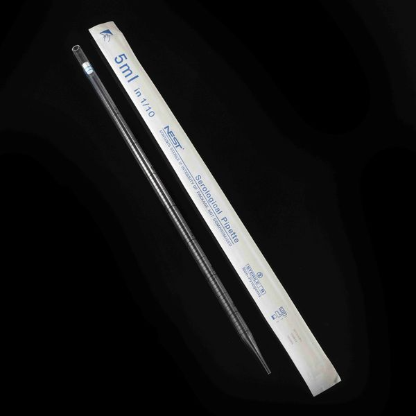 A clear 5ml NEST serological pipette laid diagonally next to its white paper-plastic wrapper.