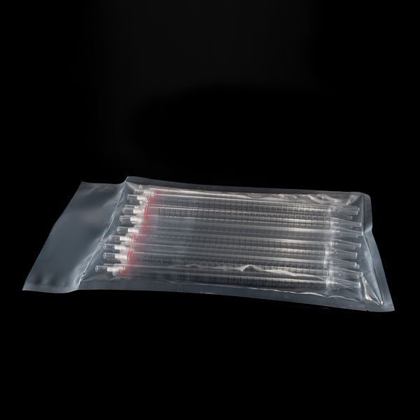 Clear plastic serological pipettes with red color bands, stacked inside a sealed transparent bulk bag on a black surface.
