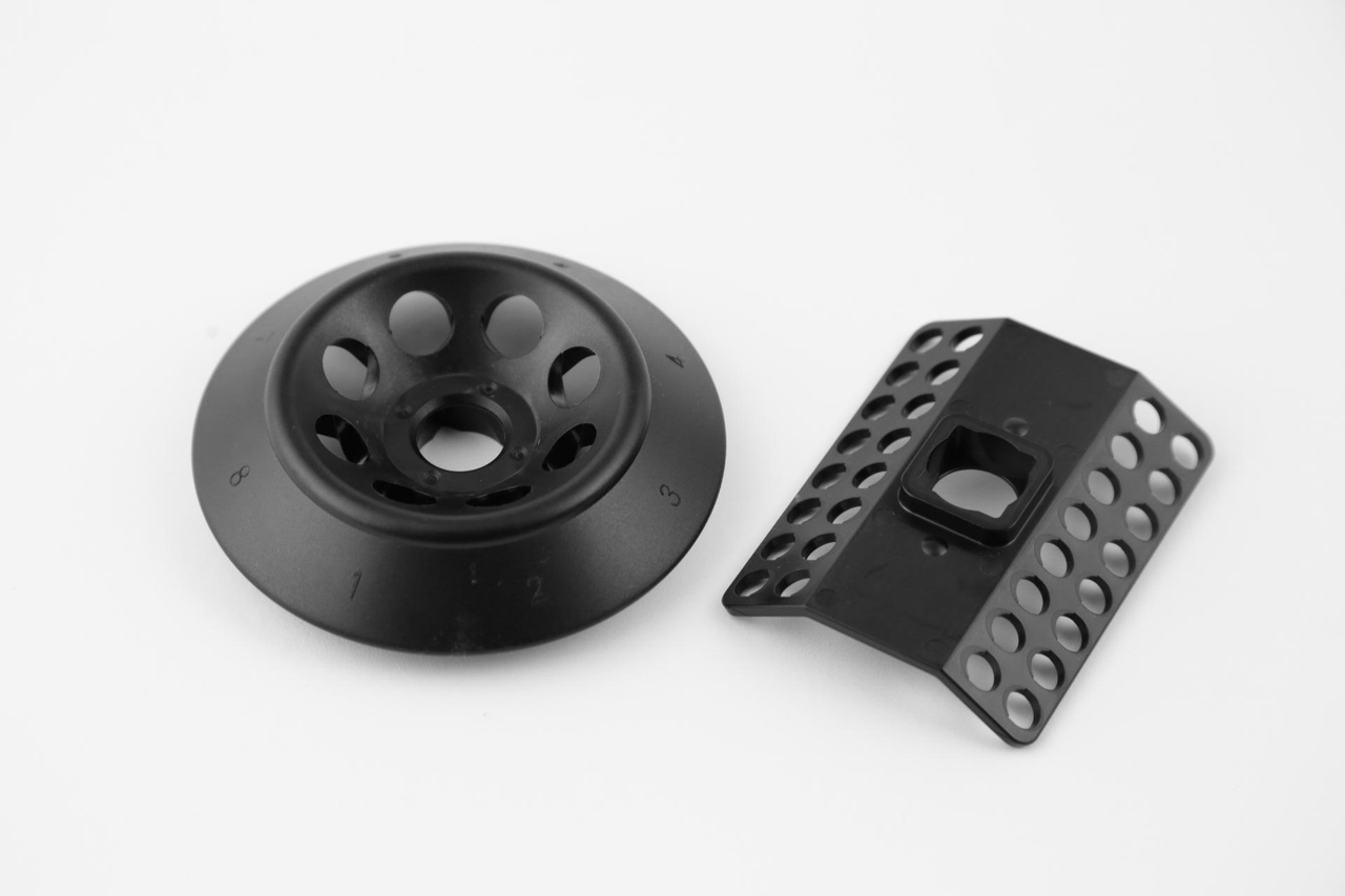 Two black plastic rotors for a microcentrifuge: a round 8-place rotor and an angled PCR strip rotor.