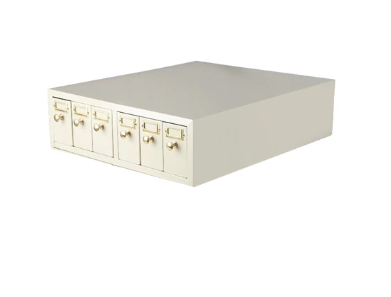 Beige metal slide storage cabinet with six small drawers and brass knobs, viewed at an angle.