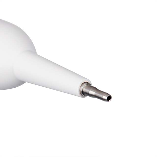 Close-up of a white plastic pipette tip cone with a silver metal nozzle at the end.