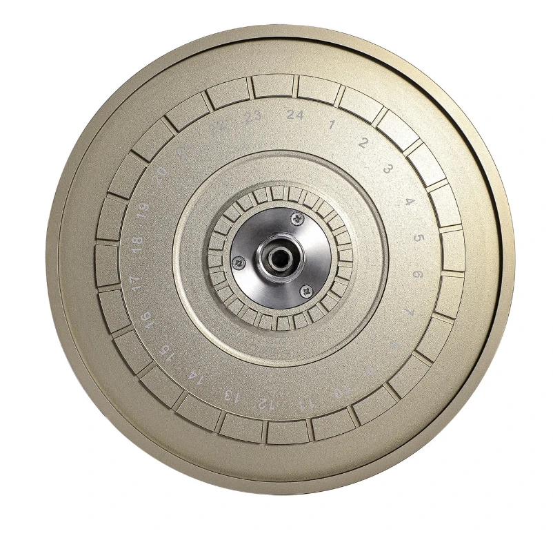 Top-down view of a circular gold-colored hematocrit centrifuge rotor with 24 numbered slots and a metal center hub.