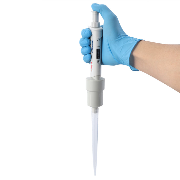 A gloved hand holding a white 4E's Precipette single-channel pipette with a clear tip against a white background.
