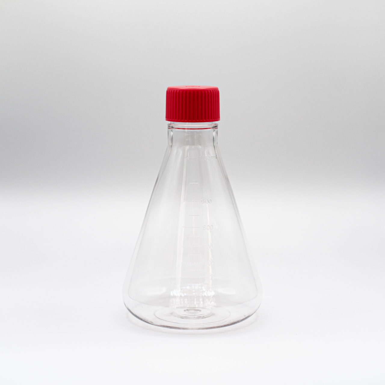 Clear 1000mL PETG Erlenmeyer flask with flat bottom and red vent cap, standing on a white background.