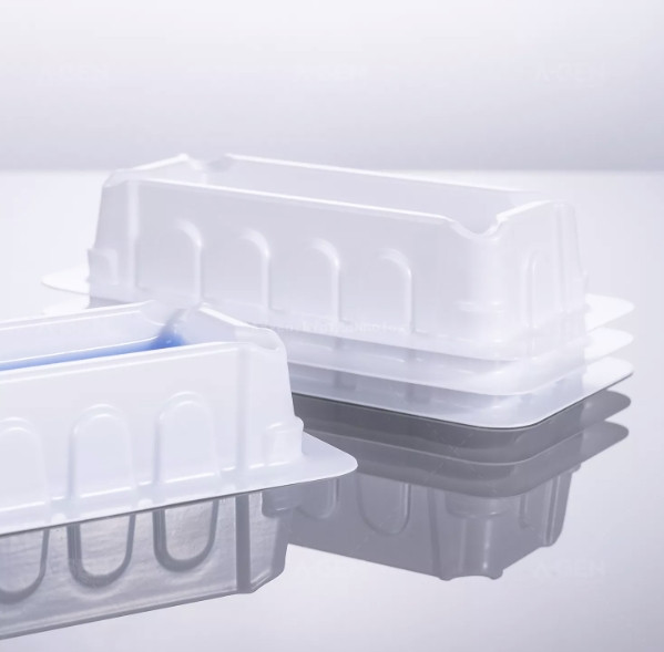Stack of white sterile polystyrene reagent reservoirs with tapered V-bottoms.