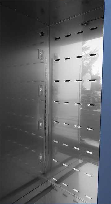 Inside view of a large stainless steel incubator with a vertical array of four electrical outlets on the left wall and