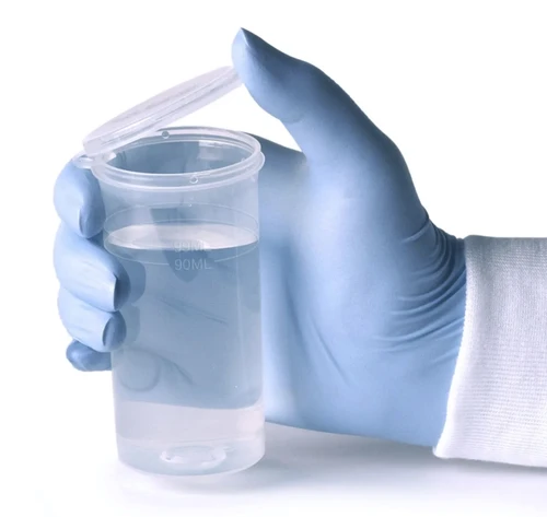 Gloved hand holding a clear plastic dilution bottle with a hinged flip-top lid.