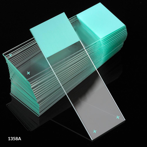 A stack of aqua frosted glass microscope slides with a single slide angled in front.