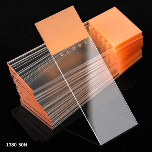 Orange frosted glass microscope slides stacked with one slide angled forward.