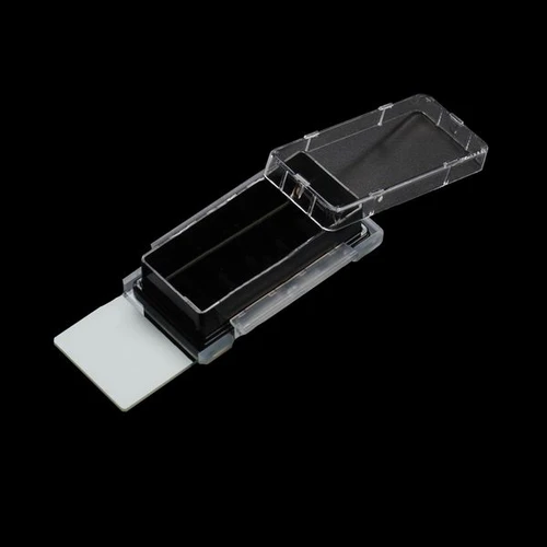 NEST black 1-well cell culture chamber slide with glass base and open clear plastic lid, angled view.