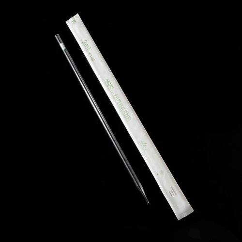 A transparent 2ml NEST serological pipette next to its white paper wrapper on a black background.