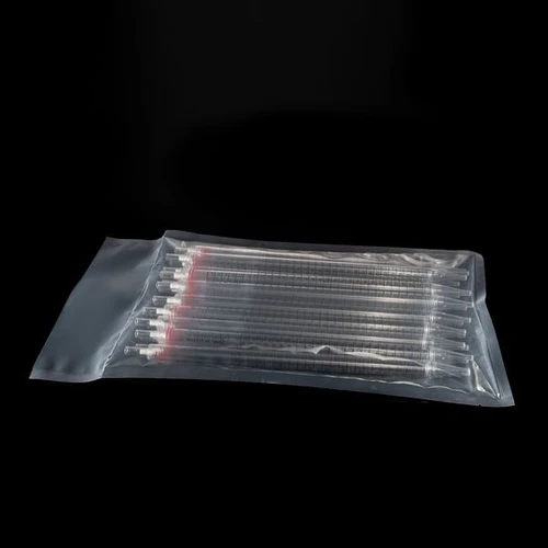 Clear plastic serological pipettes with red color bands, stacked inside a sealed transparent bulk bag on a black surface.