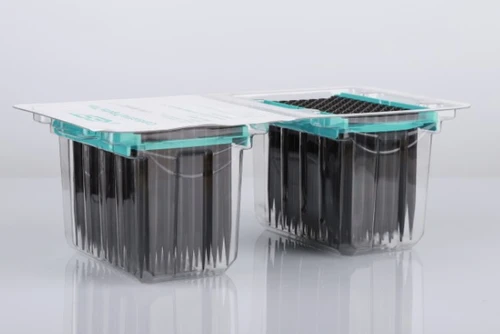Two blister packs of black conductive robotic pipette tips on a white background.