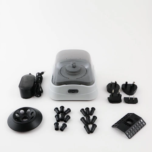 A gray Labnet mini microcentrifuge with its power supply, interchangeable rotors, adapters, and plug attachments.