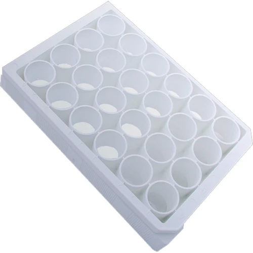 An angled view of a white plastic 24-well microplate with opaque cylindrical wells.