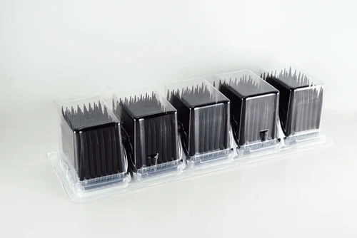 Five clear plastic blister packs of black conductive robotic pipette tips on a white background.
