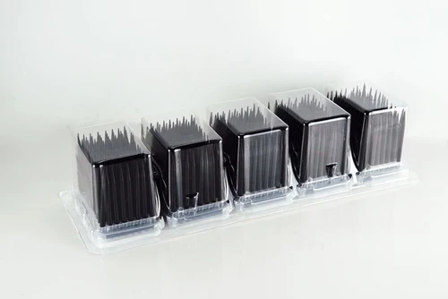 Five blisters of sterile black robotic pipette tips in clear plastic packaging, angled view.