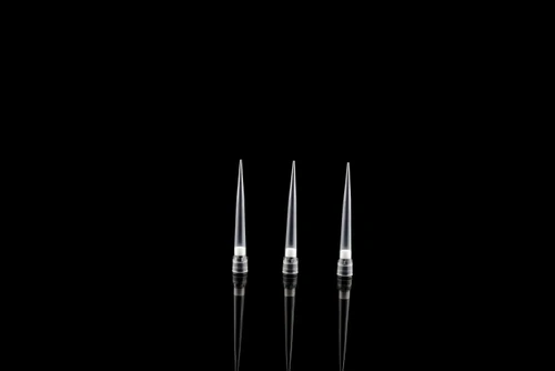 Three clear plastic robotic filter tips with white aerosol filters, upright against a black background.