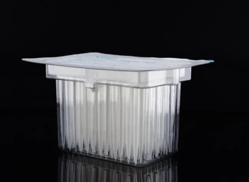 NEST Scientific clear robotic pipette tips in a sealed sterile pack on a black background.