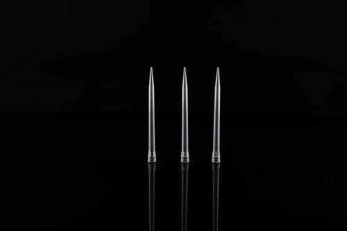 Three clear plastic robotic pipette tips standing upright against a black reflective surface.