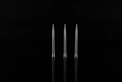 Three clear plastic pipette tips standing upright on a reflective black surface.
