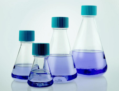 Four clear plastic Erlenmeyer flasks with blue plug-seal caps, containing blue liquid.