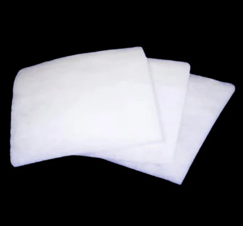 Three stacked white rectangular synthetic prefilters viewed from an angled perspective.