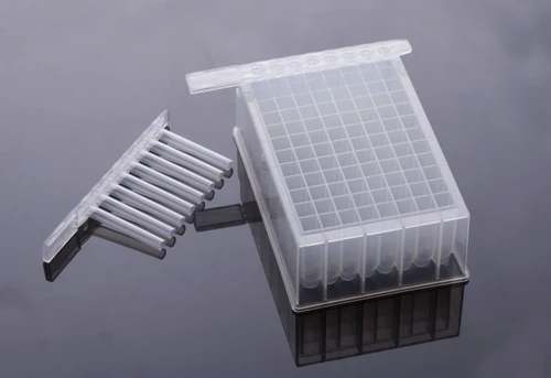 Clear plastic 96-well deep well plate with U-bottom square wells, shown with an 8-strip tube insert on a reflective surface.