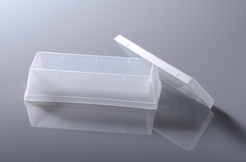 Translucent plastic 60mL reagent reservoir with lid angled on reflective surface.